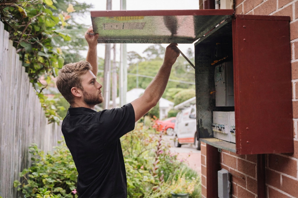 Electrician installing downlights in a Elizabeth Bay home